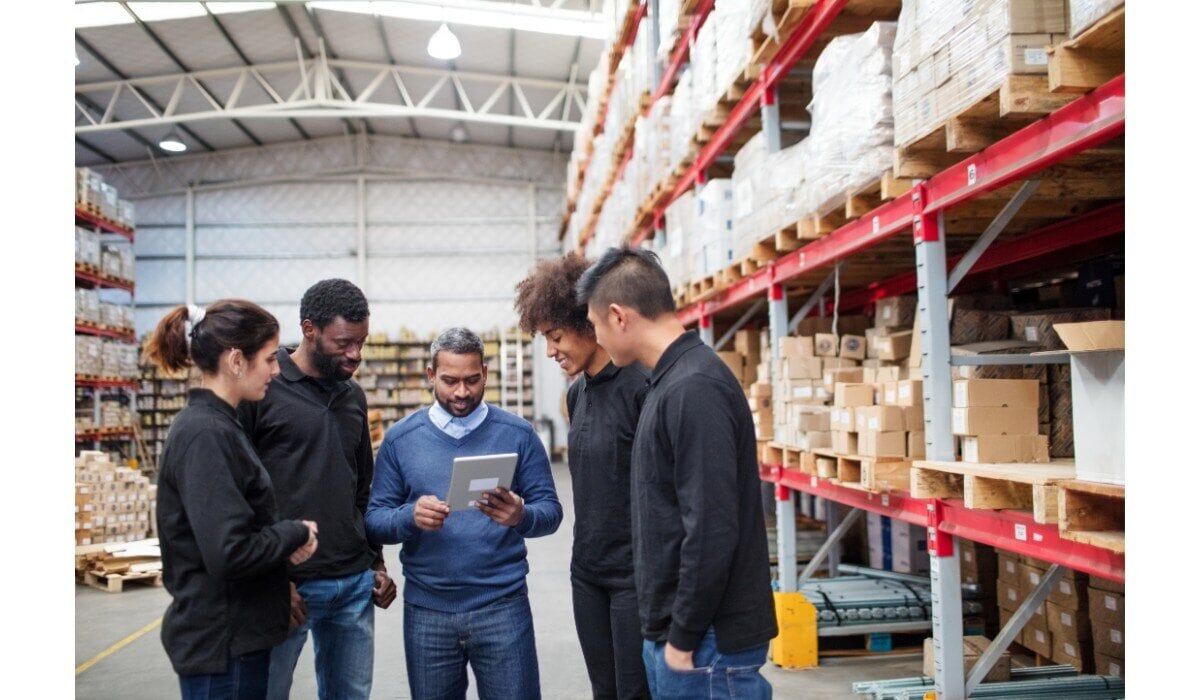 workers20in20warehouse20looking20at20tablet-2